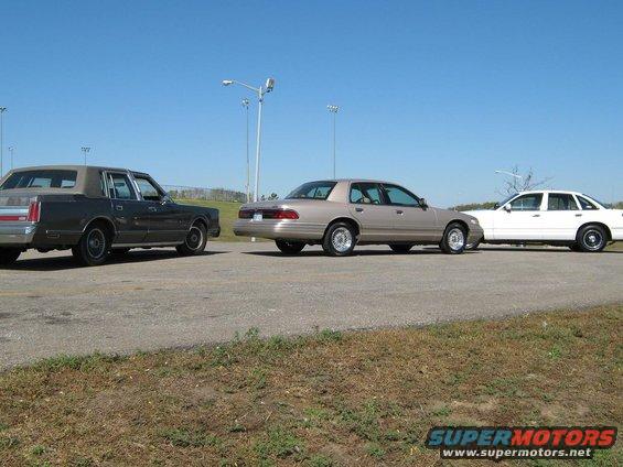 Lincoln Town Car, Mercury Grand Marquis, and a white sedan parked side-by-side
