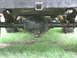 1973 Ford Bronco - Underside view of a vehicle's rear axle and suspension system, showing leaf springs and a differential housing.