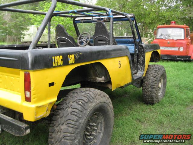 Yellow 1973 Ford Bronco with roll cage and off-road tires. LEBC ISD 5 visible