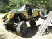 1973 Ford Bronco - This modified vehicle is positioned on an incline ramp, with its spare tire prominently displayed on the side.