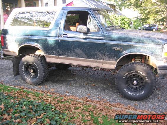 Green 1994 Ford Bronco side view, lifted with off-road tires
