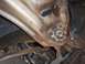 1971 Chevrolet Camaro - Close-up view of a rusty undercarriage component, showing bolts and some fluid leakage.