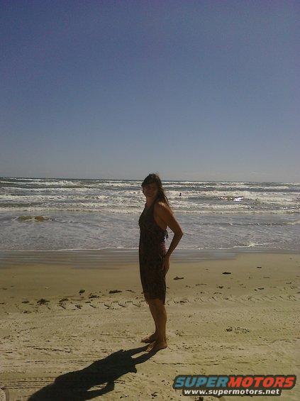 Woman in dress on beach with ocean waves