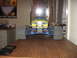 1992 Ford Ranger - A yellow remote control monster truck sits on a wooden surface, with a poster and blinds in the background.