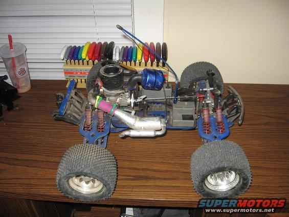 Remote control nitro car with blue body parts and silver exhaust pipe