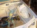 1995 Ford Taurus - The white painted car frame shows areas of rust and is partially covered with protective tape.