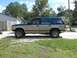 1992 Ford Explorer - This 1992 Ford Explorer features a distinctive tan and teal two-tone paint scheme and is shown from the side.