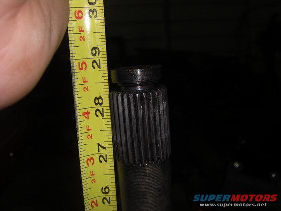 Splined shaft measured with a yellow tape measure showing approximately 28 inches