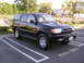 2000 Toyota 4Runner - This black 2000 Toyota 4Runner is parked in a lot, showing its front 3/4 view.