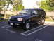 2000 Toyota 4Runner - A black 2000 Toyota 4Runner is parked in a lot, showing its front three-quarter view.