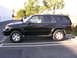 2000 Toyota 4Runner - Side view of a black 2000 Toyota 4Runner parked in a lot.