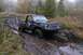 1988 Chevrolet Blazer - A black 1988 Chevrolet Blazer navigates a muddy trail, demonstrating its off-road capabilities.