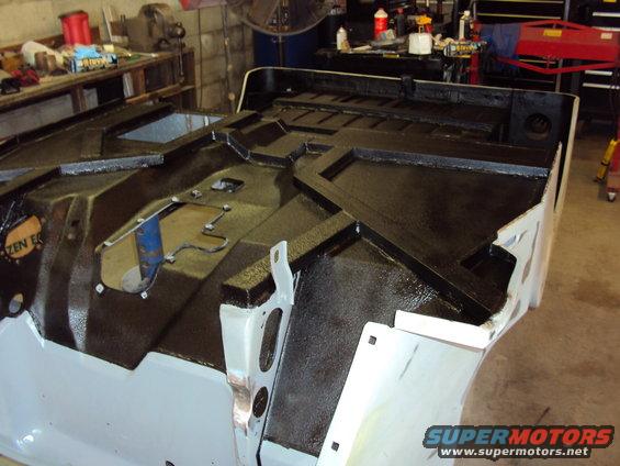 Jeep tub interior with black protective coating and visible structural details