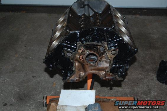 Black engine block on an orange stand