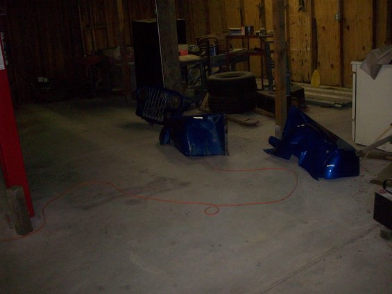 Blue Jeep CJ5 fender and grille in garage