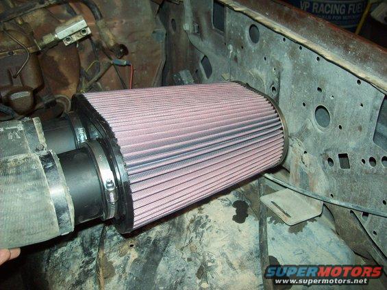 Aftermarket conical air filter installed in a vehicle's engine bay