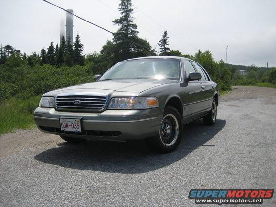 1998 Ford Crown Victoria parked on gravel road, front 3/4 view. License plate GGW-035