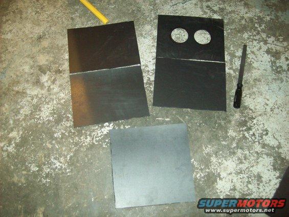 three pieces of black material, one with two circles cut out, on a concrete floor with a screwdriver and yellow rod
