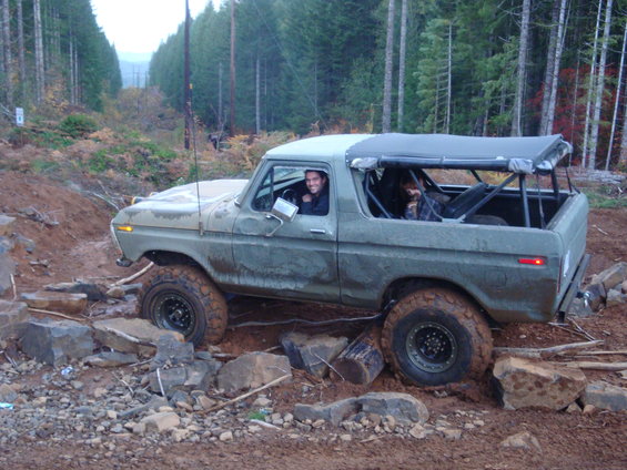 Green 1978 Ford Bronco on rocky off-road trail