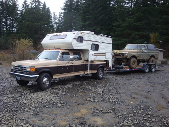 Brown 1978 Ford Bronco on trailer, 3/4 front view. Lifted with off-road tires