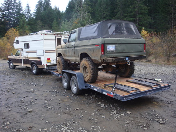 Green 1978 Ford Bronco on trailer, rear view. License plate visible
