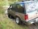 1992 Ford Explorer - This two-tone Ford Explorer is navigating a muddy trail with its tires partially submerged.