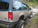 1992 Ford Explorer - This lifted Ford Explorer navigates a challenging muddy off-road path.