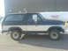 1985 Ford Bronco - This 1985 Ford Bronco features a classic two-tone paint scheme with dark blue on top and white on the bottom.