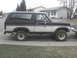 1985 Ford Bronco - This 1985 Ford Bronco is shown from the side, parked on a suburban street.