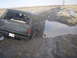 1985 Ford Bronco - This 1985 Ford Bronco is stuck deep in mud on a rural road.