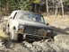 1985 Ford Bronco - This SUV is shown off-roading through a challenging muddy path.