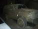 1985 Ford Bronco - This 1985 Ford Bronco is heavily covered in mud, obscuring most details but retaining its distinctive body style.