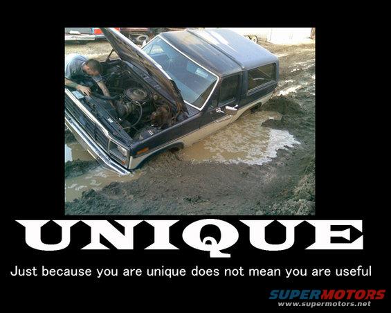 1985 Ford Bronco stuck in mud with hood open