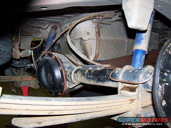 underneath view of rear axle, leaf springs, and blue shocks
