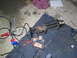 1984 Ford Bronco II - Winch and associated electrical components are spread out on a garage floor with tools.