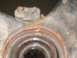 1999 Volkswagen Beetle - This image shows a close-up view of a heavily rusted metal component, likely a part from a vehicle's undercarriage.