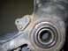 1999 Volkswagen Beetle - A close-up view of a worn and rusty vehicle suspension component, showing a bearing assembly.