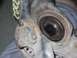 1999 Volkswagen Beetle - Close-up of a rusty metal automotive suspension component with yellow markings.