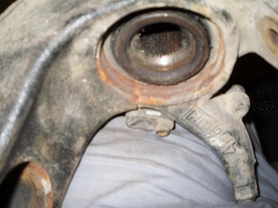 Close-up of a worn wheel bearing housing with visible splines inside the opening