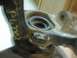 1999 Volkswagen Beetle - A close-up view of a metal automotive part, possibly a suspension component, with yellow markings.