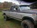 1991 Ford F-150 - This lifted 1991 Ford F-150 pickup truck features a two-tone paint scheme and aggressive off-road tires.