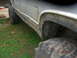 1991 Ford F-150 - This lifted truck features oversized tires and a side view that highlights its substantial ground clearance.