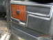 1991 Ford F-150 - Close-up of a vehicle's interior door panel showing a wood-look insert and chrome accents.