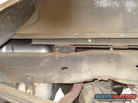 Body mount just above the rear axle.
