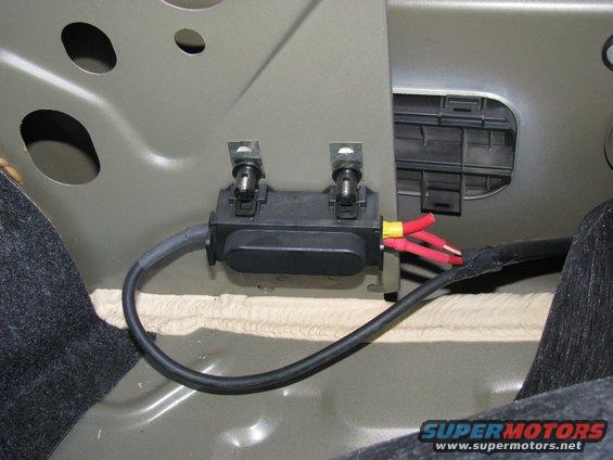 In the trunk, behind the carpet on the passenger side fender. 