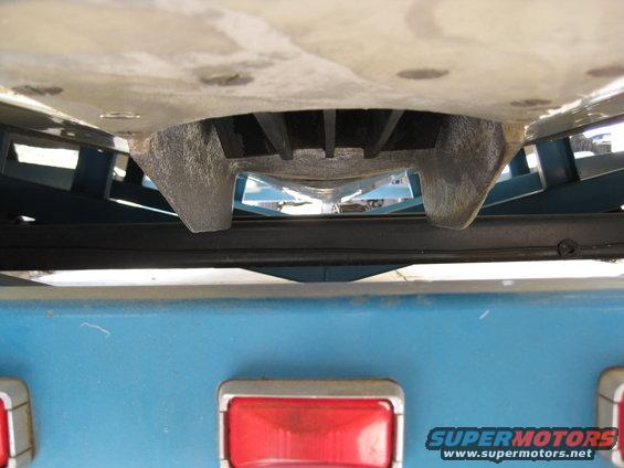 Close-up of a boat trailer hitch receiver with blue trailer body and red taillight visible