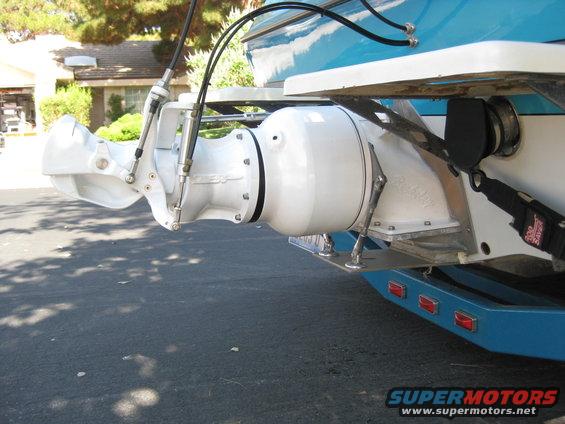 Close-up of a boat's jet drive system, showing the white impeller housing and steering nozzle