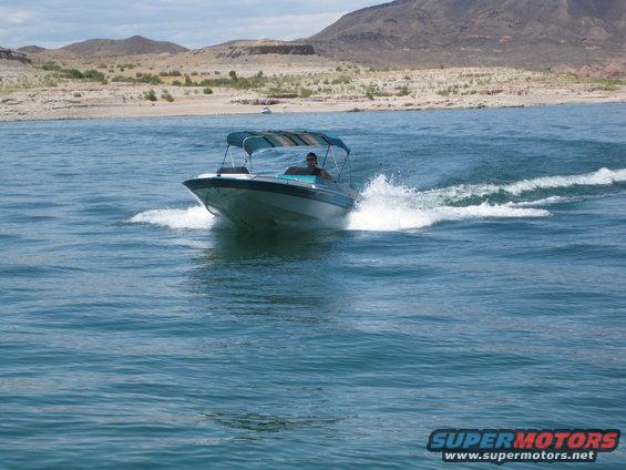 Boat with blue canopy on choppy water