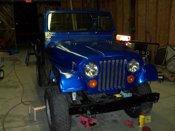 Blue 1978 Jeep CJ5 with a black bumper and chrome grille, parked indoors