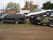 2000 Ford Excursion - A black Ford Excursion tows a car carrier loaded with a white sedan.